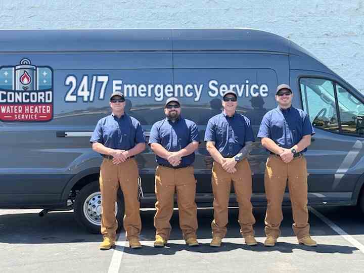 Concord Water Heater Service technicians standing in front of their service van